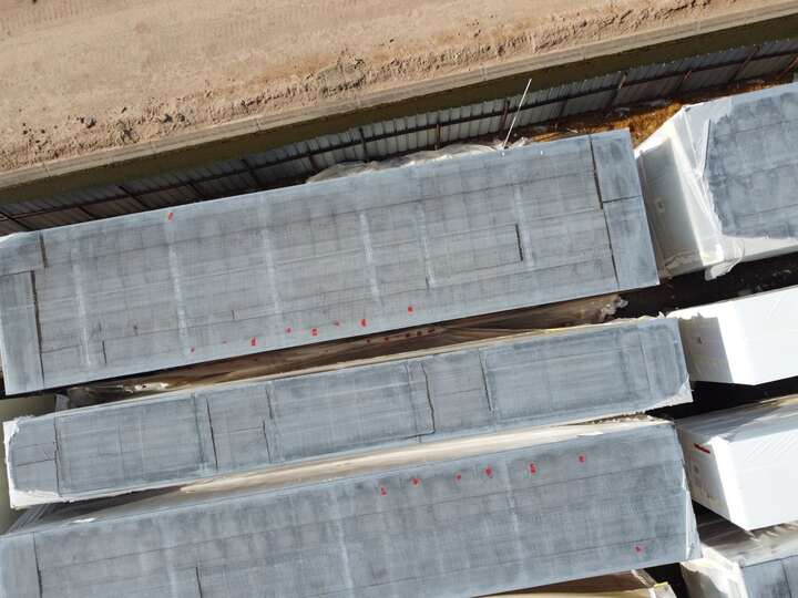 Aerial view of wrapped modular data center sections staged in the storage yard